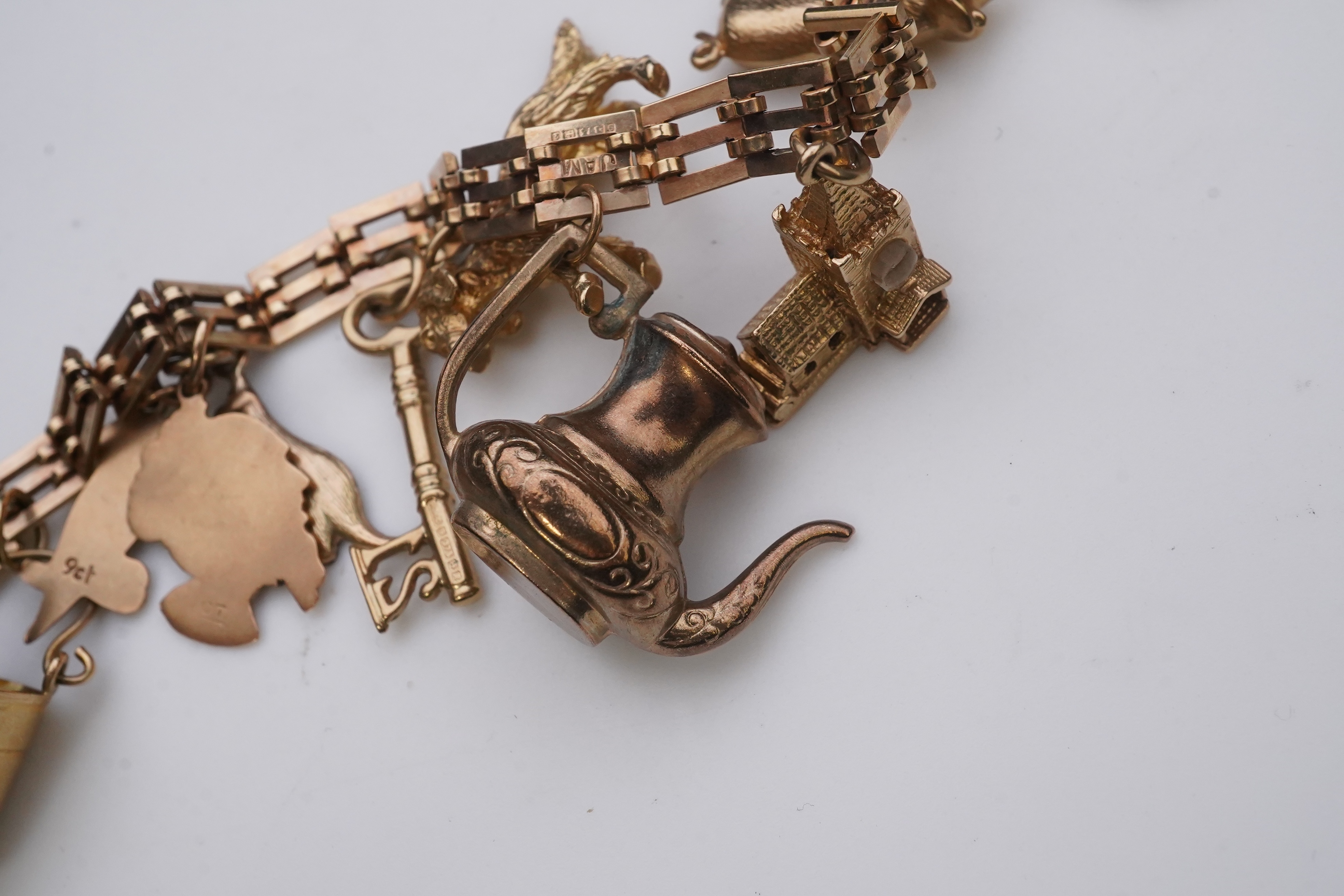 A charm bracelet, mid 20th century